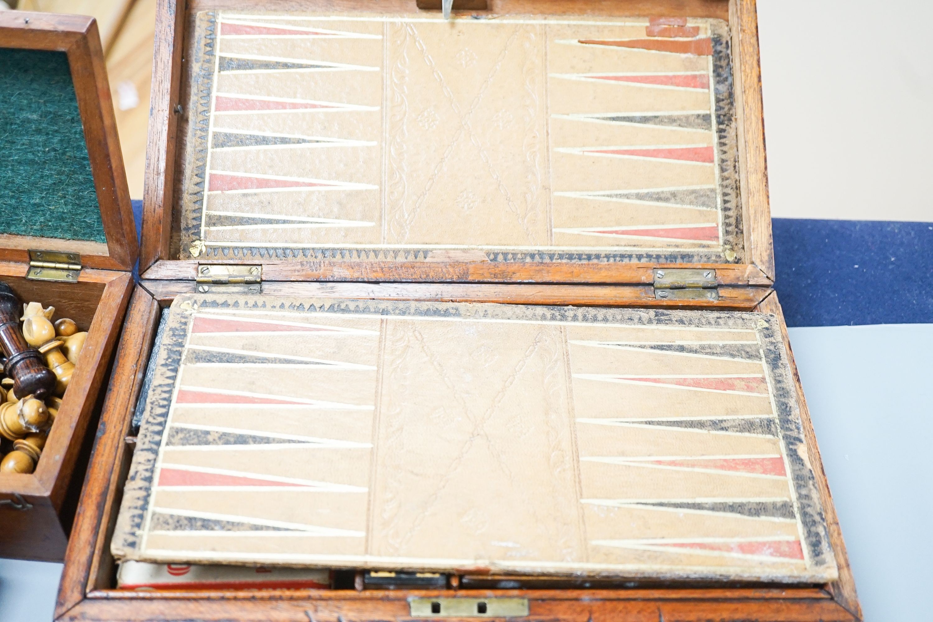 A Victorian brass inset mahogany games box, fitted with solitaire, cribbage, chessmen, draughts etc., 33cm, a turned and stained bone chess set, another games box containing chessmen and draughts
